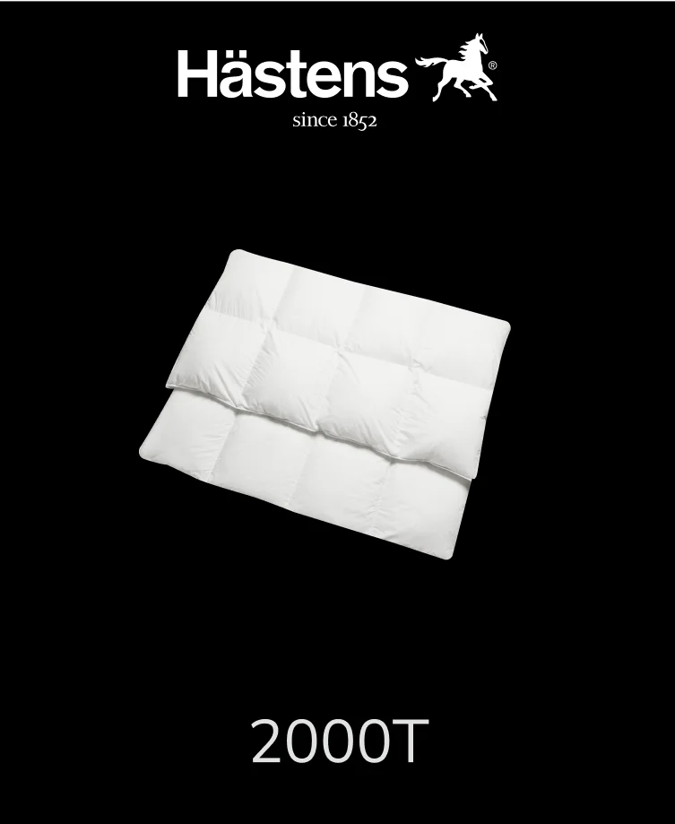 Luxurious Hastens 2000T white down comforter on a neatly made bed